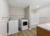 Thumbnail 29 of 53 - A laundry room with a washer and dryer.