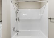 Thumbnail 33 of 53 - A white bathroom with a shower stall.