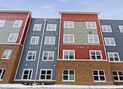 Thumbnail 28 of 53 - A multi-story apartment building with various colored exteriors.