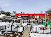 Thumbnail 36 of 53 - A playground with a green slide and red and blue slide.