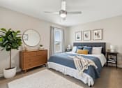 Thumbnail 15 of 15 - A bedroom with a bed, dresser, and ceiling fan.