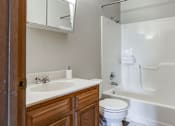 Thumbnail 29 of 29 - A white sink and toilet in a bathroom.