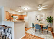 Thumbnail 27 of 30 - A kitchen with a table and chairs in the middle of the room.