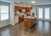 Thumbnail 27 of 30 - A kitchen with wooden cabinets and a white refrigerator.