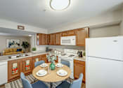 Thumbnail 28 of 28 - A kitchen with a table set for two.