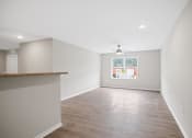 Thumbnail 16 of 19 - an empty living room with a ceiling fan and a window