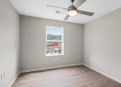 Thumbnail 8 of 19 - an empty room with a window and a ceiling fan