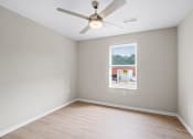 Thumbnail 6 of 19 - an empty room with a ceiling fan and a window