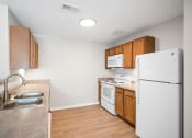 Thumbnail 11 of 19 - a kitchen with a white refrigerator and a sink