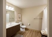 Thumbnail 24 of 24 - A bathroom with a toilet, sink, and mirror.