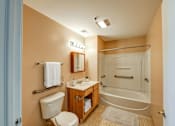 Thumbnail 26 of 26 - A bathroom with a toilet, sink, and bathtub.