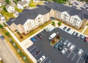 Thumbnail 40 of 48 - an aerial view of a large apartment complex with cars parked in the parking lot