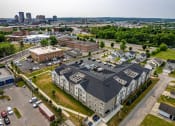 Thumbnail 44 of 48 - a large building with a gray roof and a parking lot in front of it