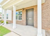 Thumbnail 8 of 29 - the front door of a brick house with two pillars in front of it