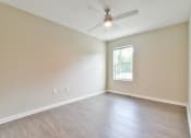 Thumbnail 27 of 29 - a bedroom with hardwood floors and a ceiling fan