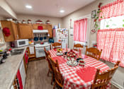 Thumbnail 5 of 27 - a kitchen with a red and white checkered table cloth