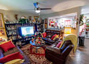 Thumbnail 3 of 27 - a living room filled with leather furniture and a flat screen tv