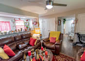Thumbnail 13 of 27 - a living room with couches and a table