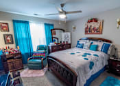 Thumbnail 8 of 27 - a bedroom with a bed and a ceiling fan