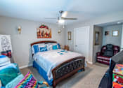 Thumbnail 9 of 27 - a bedroom with a bed and a ceiling fan