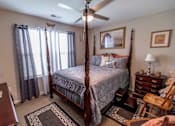 Thumbnail 22 of 27 - a bedroom with a bed and a ceiling fan