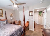 Thumbnail 25 of 27 - a bedroom with a bed and a ceiling fan