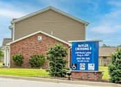 Thumbnail 19 of 27 - a sign in front of a brick house that says butter crossing ii
