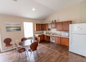 Thumbnail 15 of 27 - a kitchen with wooden cabinets and a white refrigerator
