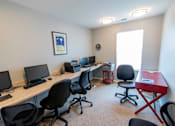 Thumbnail 27 of 27 - a room with four computers and four chairs