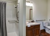 Thumbnail 19 of 22 - A bathroom with a toilet, sink, and shower.