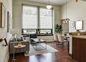 Thumbnail 21 of 22 - A modern kitchen with a dining table and chairs.