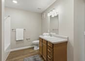 Thumbnail 52 of 53 - A bathroom with a white sink and a white towel hanging on the wall.