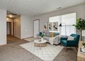 Thumbnail 26 of 27 - A living room with a grey carpet and a white rug.