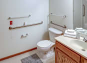 Thumbnail 29 of 29 - A white toilet sits next to a sink in a bathroom.