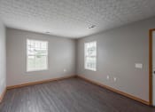 Thumbnail 45 of 83 - A room with a wooden floor and a white door.