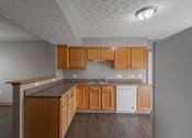 Thumbnail 41 of 83 - A kitchen with wooden cabinets and a white dishwasher.