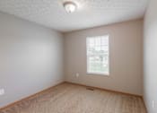 Thumbnail 43 of 83 - A room with a window and a carpeted floor.