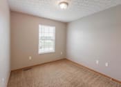 Thumbnail 59 of 83 - A room with a carpeted floor and a window.
