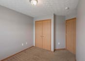 Thumbnail 53 of 83 - A room with two doors and carpeted floor.