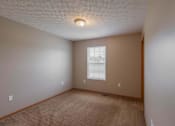 Thumbnail 55 of 83 - A room with a carpeted floor and a window.