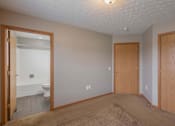 Thumbnail 52 of 83 - A room with a toilet visible through the open door.