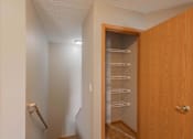 Thumbnail 82 of 83 - A small kitchen with a wooden door and a refrigerator.