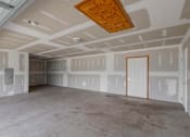 Thumbnail 37 of 83 - A room with a wooden ceiling and walls covered in drywall.