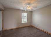 Thumbnail 36 of 83 - Empty room with a ceiling fan and a window.