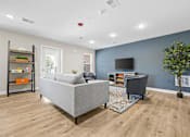 Thumbnail 8 of 31 - A living room with a grey sofa and a grey armchair.