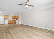 Thumbnail 20 of 31 - A room with a ceiling fan and wooden flooring.