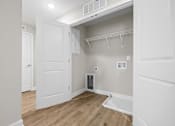 Thumbnail 19 of 31 - A small room with a white door and a white cabinet above it.