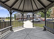 Thumbnail 25 of 31 - A gazebo with a black railing and a concrete floor.