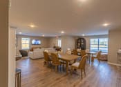 Thumbnail 10 of 55 - A dining room with a wooden table and chairs.