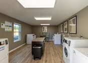 Thumbnail 4 of 55 - A laundry room with a washer and dryer on the right and a washing machine on the left.